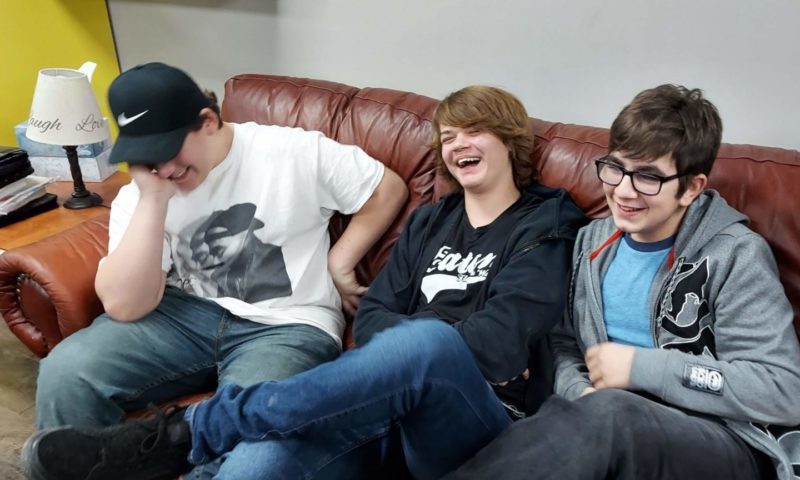 3 boys sitting on couch on the about page
