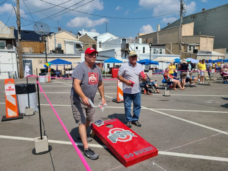 Two Men Playing in the Toss for Teens Corn Hole Tournament