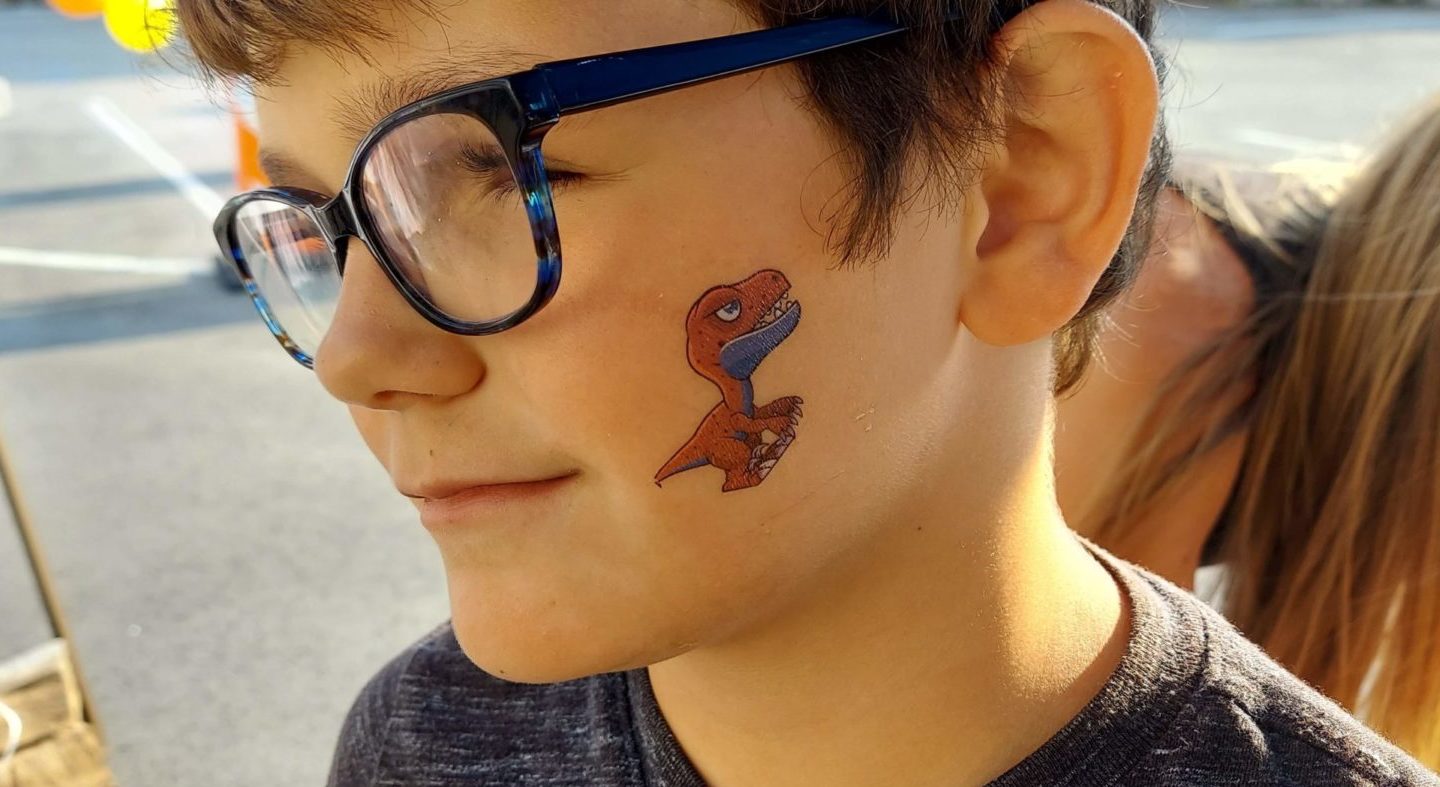 Boy getting his face painted at YFC Summerfest